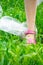 Plastic bags trash with children`s feet on green grass