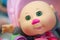 Plastic bald doll with green eyes pink nose