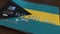 Plastic bank card featuring flag of Bahamas. Bahamian national banking system related animation