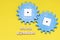 Plastic blue gears on a yellow background, signature workflow. Interaction concept. The photo