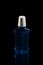 Plastic bottle  blue sanitizer. Black background