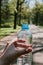 Plastic bottle of clean drinking water in hand, source of life