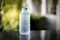 Plastic bottle of drink water and reflection on table with sunlight at daylight,Cold water concept