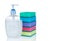 Plastic bottle liquid soap and multicolor sponges on white background