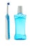 Plastic bottle of mouthwash and electrical toothbrush on white b