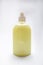 Plastic bottle of yellow antiseptic soap with dispenser on a white background