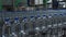 Plastic bottles of mineral water move along the conveyor in three rows. Production of drinking water at a food processing plant