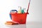 Plastic bucket with detergents on a white background