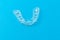 Plastic cap for teeth on a blue background