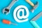 Plastic carpentry tools and email symbol abstract isolated on blue