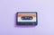 plastic cassette on violet background. Retro music concept