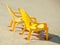 Plastic chairs stands sideways on beach near sea at dawn