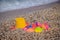 Plastic children`s toys for sand on the background of the sea. Kids toys. Plastic sand toys. Bright toys. Sand construction.