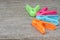 Plastic clothespin in many colors on wood background