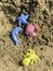 Plastic colored shapes in sand on the beach