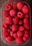 Plastic container full of fresh rasberries