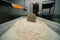 Plastic container with healthy wholegrain flour close-up. In the background is an infrared heater. Industrial bakery