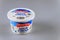 Plastic container of sour cream, produced by Friendly Farms USA on a gray isolated background