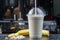 Plastic cup of milkshake with banana