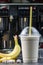 Plastic cup of milkshake with banana