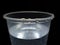 Plastic cup with water, dramatic illumination