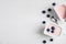 Plastic cups with tasty yogurts and blueberries on white wooden table, flat lay. Space for text