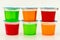 In plastic cups, there are various flavors of Jello-O gelatin snacks.