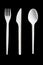 Plastic cutlery on black background