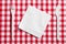 Plastic cutlery on checkered tablecloth