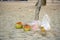 Plastic debris and coconut on the sand in Thailand