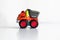 Plastic dump truck toy construction vehicle isolated on white background with reflection