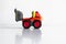 Plastic dump truck toy construction vehicle isolated on white background with reflection