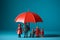 Plastic figures in the form of a family protected by a red umbrella. Insurance concept