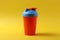 A plastic fitness bottle on yellow background