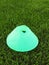 Plastic football green turf playground with grinded black rubber in core and bright green blue plastic cone.