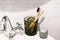Plastic free bathroom items. Eco natural bamboo toothbrushes in glass and organic charcoal toothpaste in glass jar on sink in