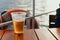 Plastic glass with beer is on table on board ship