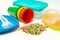 Plastic granules and disposable tableware made of polyethylene, polypropylene polymeric material on a white background. BPA FREE
