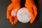 Plastic granules . Polyethylene pellets and hands with orange gloves. Quality control of plastic in the laboratory in production.