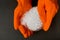 Plastic granules . Polyethylene pellets and hands with orange gloves. Quality control of plastic in the laboratory in production.
