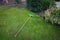 Plastic grass rake with a wooden handle