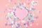 Plastic heart on pink background with confetti