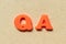 Plastic letter in word QA abbreviation of quality assurance or question and answer on wood background