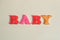 Plastic letters message baby on white isolated background