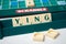 Plastic letters with word ying on Scrabble board game