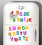 Plastic magnetic alphabet letters displayed on vintage refrigerator