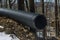 Plastic main black pipes on heap of polyethylene pipes for a drain supply system for laying of city communications