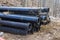 Plastic main black pipes on heap of polyethylene pipes for a water supply system for laying of city communications