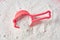 Plastic measuring spoon on heap of washing powder for cleaning clothes in laundry