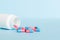 plastic medicine bottle with capsules of pills on colored background. Online pharmacy. Painkiller medicine and